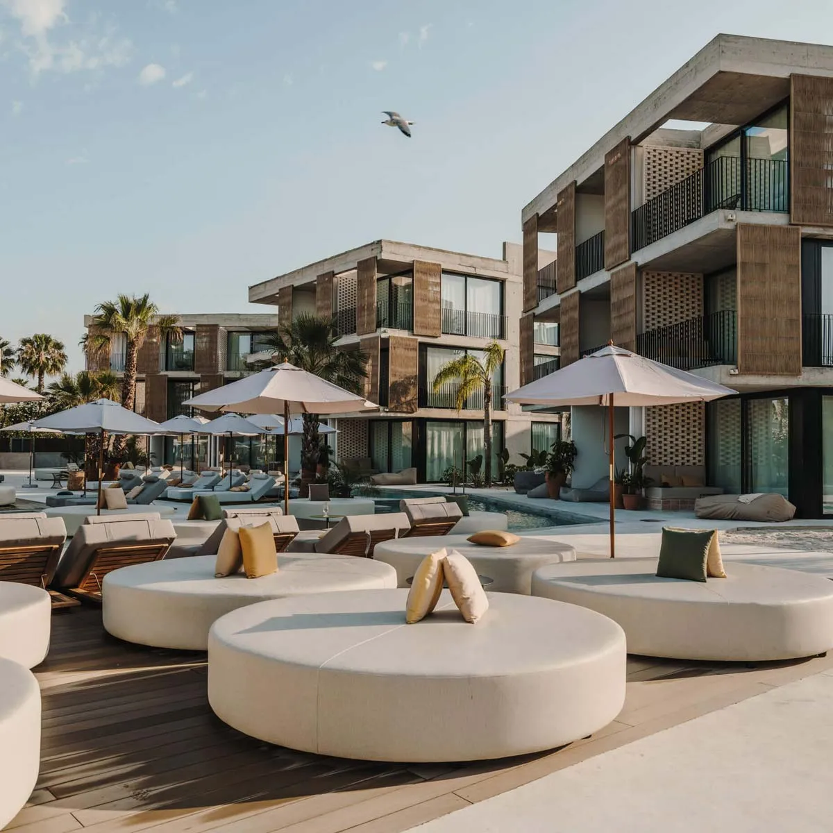 camas balinesas circulares en beach club con mobiliario exterior resistente